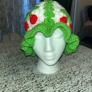 Green and White Crochet Hat with Red Accents